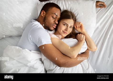 Young Black Guy Sleeping And Hugging His Beautiful Caucasian Girlfriend