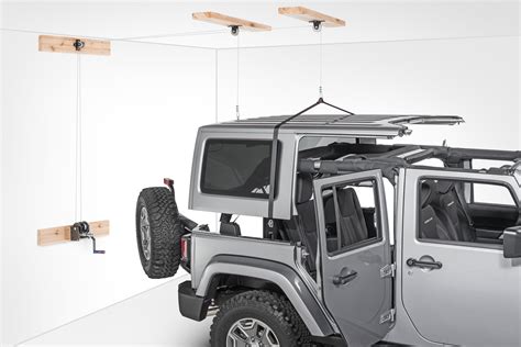 Lay the hoist bar onto the hard top and connect the hooks. Lange Originals® 014-SIM Hoist-A-Top Simple Jeep CJ & Wrangler | Quadratec
