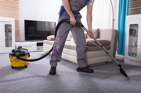 Person Cleaning Carpet With Vacuum Cleaner Stock Photo Download Image