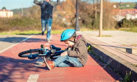 Boy With Knee Injury After Falling Off To Bicycle — Stock Photo © Doble