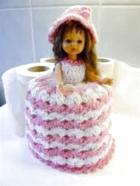 Toilet roll cosies can come in different shapes and forms but i've always liked the pretty doll who covers the toilet tissue roll with her wide skirt. Hand Knitted Raspberry/Blue Doll Toilet Roll Cover ...