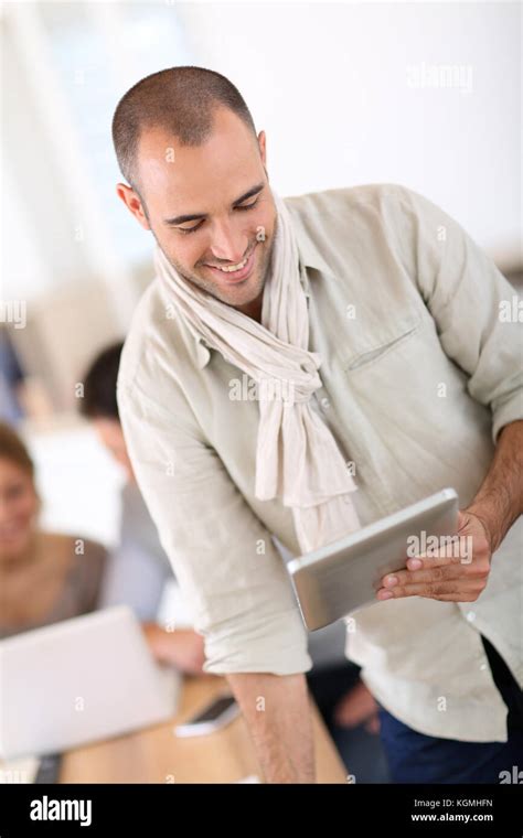 Smiling Man In Office Using Digital Tablet Stock Photo Alamy