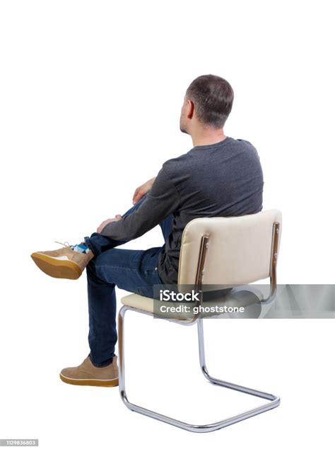 Side View Of A Man Sitting On A Chair Stock Photo Download Image Now