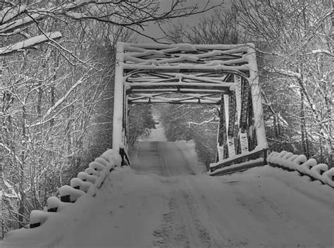 Snow Covered Bridge Crossing The Mad River In Creemore Ontario Canada