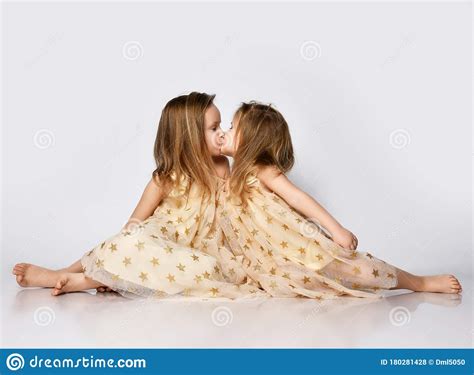 Two Small Beautiful Smiling Girls Sisters In Same Dresses With Stars