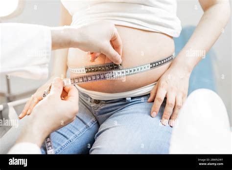 Doctor Measuring Pregnant Womans Belly With A Tape During A Medical Examination Cropped View