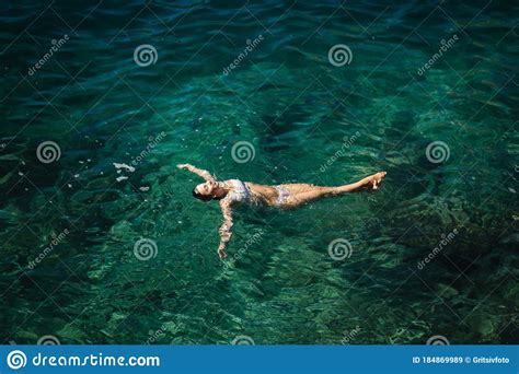 Woman In Bikini Lying On The Water Attractive Young Woman Enjoying Summer Sun Beautiful Lagoon