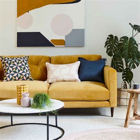 Modern Living Room With Mustard Yellow Sofa Abstract Artwork And Round