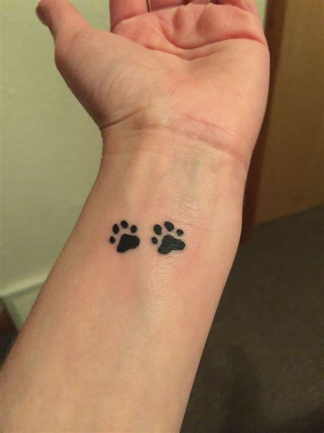 Tiny Paw Print Tattoo On Wrist