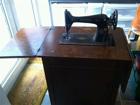 singer treadle sewing machine in cabinet