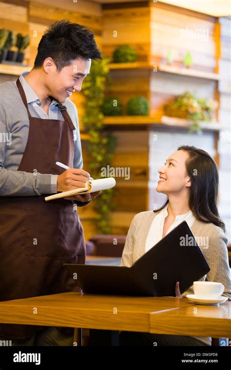 Waiter Taking Order From Woman At Restaurant Stock Photo Alamy