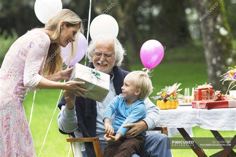 Grandfather Receiving Ts On Birthday Party In Garden — Birthday