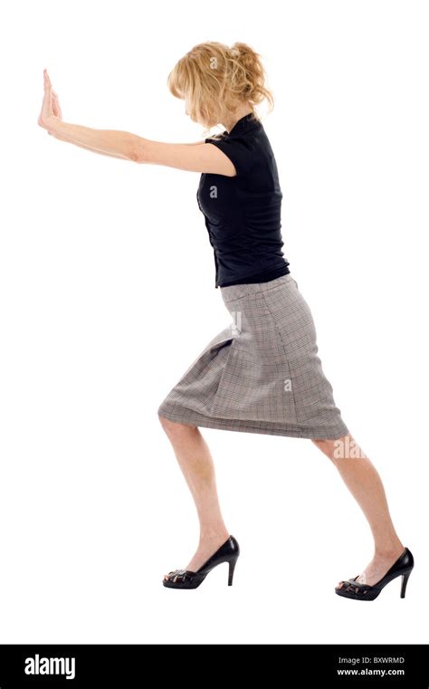 Business Woman Pushing An Imaginary Object Isolated Over A White