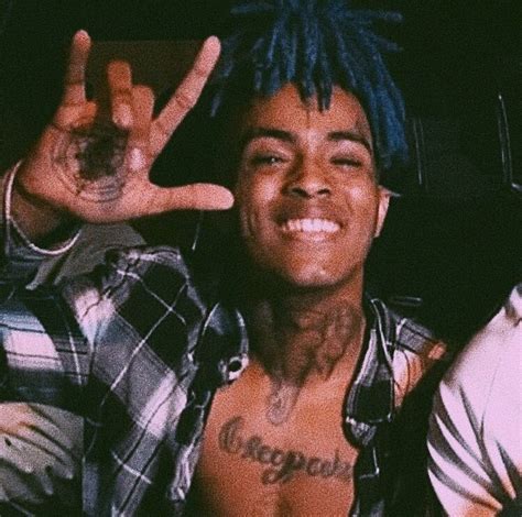 A Man With Blue Hair Making The Peace Sign