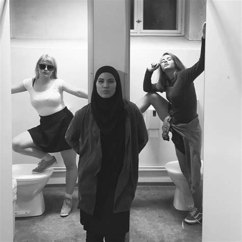 Three Women Standing In Front Of A Bathroom Mirror