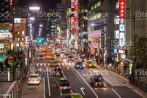 Rush Hour Commuters In Neon Night City Downtown Tokyo Japan Stock Photo