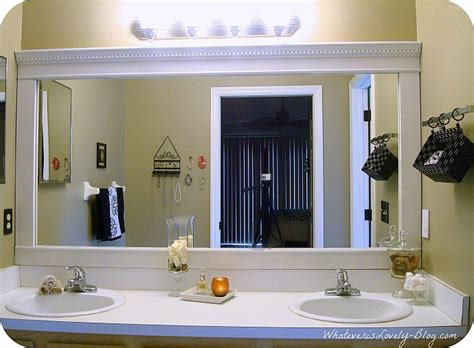 Traditional scrollwork along the outside edge of the frame is complemented by abstract molding highlighted with metallic accents. Bathroom Mirror Framed with Crown Molding