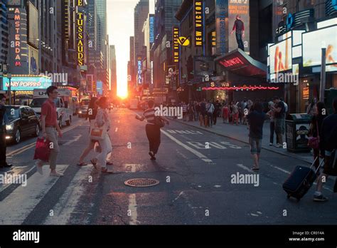 Visitors To Times Square In New York Pass The Manhattanhenge Sunset