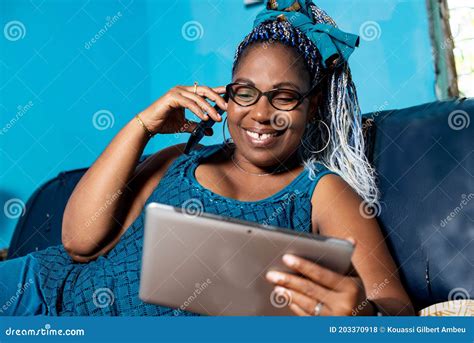 Portrait Of A Mature African Woman Happy At Mobile Phone Stock Photo