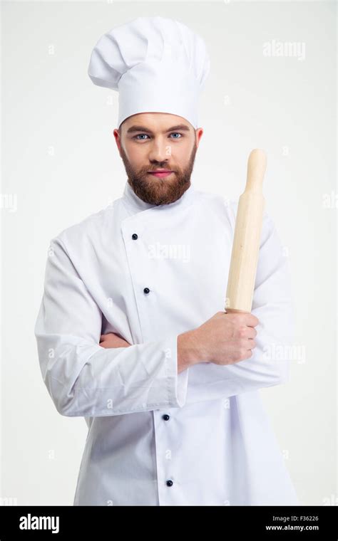 Portrait Of A Handsome Male Chef Cook Holding A Rolling Pin Isolated On A White Background Stock