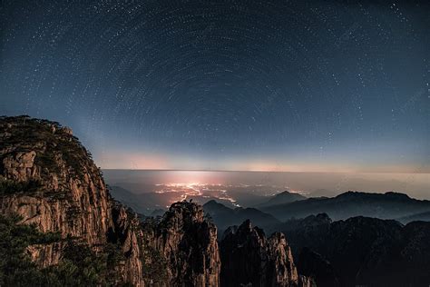 Huangshan Scenic Spot Overlooks The City And The Starry Sky From The
