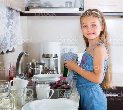 Girl Doing Dishes At Kitchen Stock Photo Download Image Now