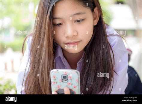 Portrait Of Thai High School Student Uniform Teen Beautiful Girl Using