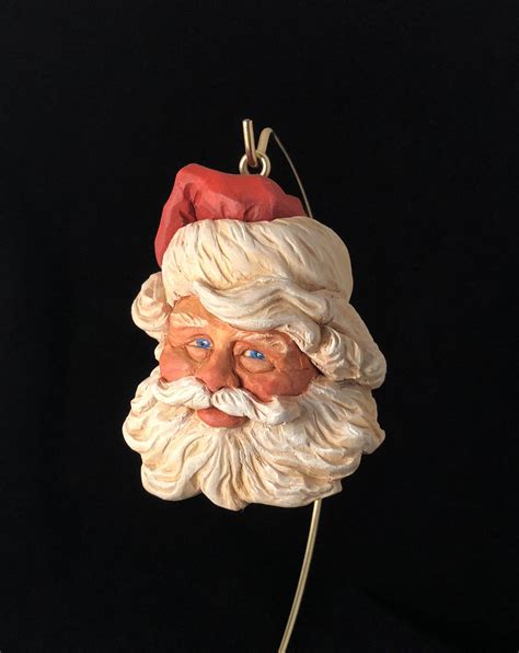 A Close Up Of A Santa Clause Head On A Black Background