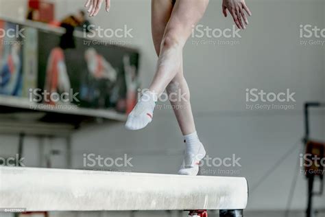 Girl Gymnast Athlete During Exercise On Balance Beam In Gymnastics