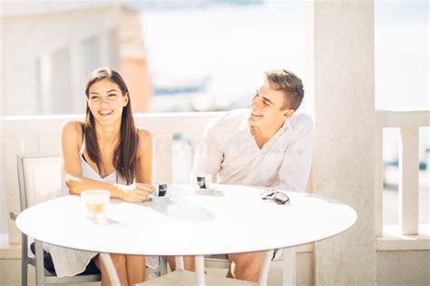 attractive couple drinking cocktails enjoying summer vacation smiling attracted to each other
