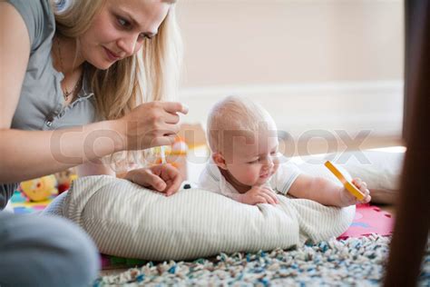 A Caucasian Mother Taking Care Of Her Son Stock Image Colourbox
