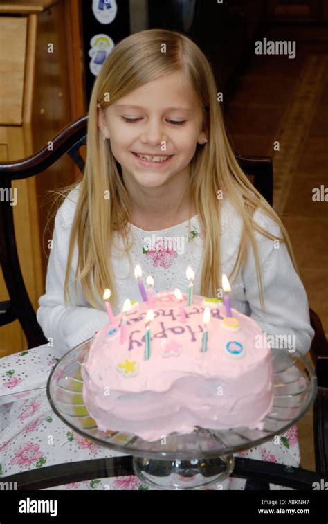 8 Year Old Girl Celebrates Her Birthday With A Cake With Candles Stock