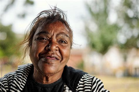 Smiling Aboriginal Woman Photographed Outdoors By Stocksy Contributor