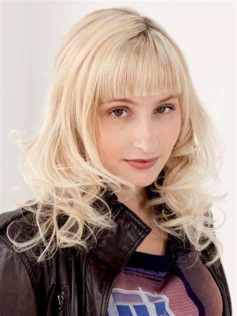 Hair · 1 decade ago. Blonde hair with straight bangs and curls around the shoulders