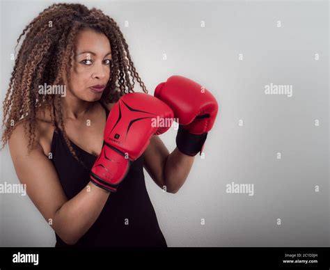 Horizontal Portrait Of An Afro American Woman Wearing Red Boxing Gloves