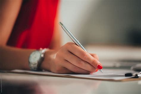 Hand Of A Businesswoman Signing A Document By Stocksy Contributor