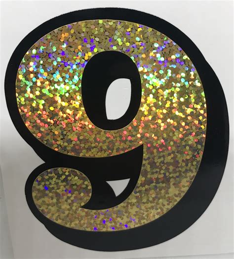 The Number Nine Is Covered With Multicolored Glitters And Black Metal