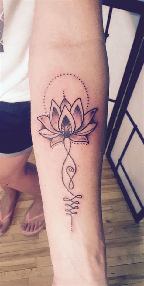A Woman S Leg With A Tattoo On It That Has A Lotus Flower In The Center
