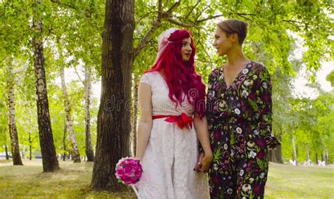 lesbian wedding the bride and groom are walking in the park stock image image of smiling