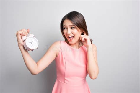 Surprised Woman Holding An Alarm Clock In Her Hand And Looking A Stock Image Image Of Timer