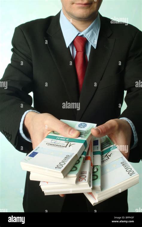 Man Holding Bundles Of Banknotes Stock Photo Alamy