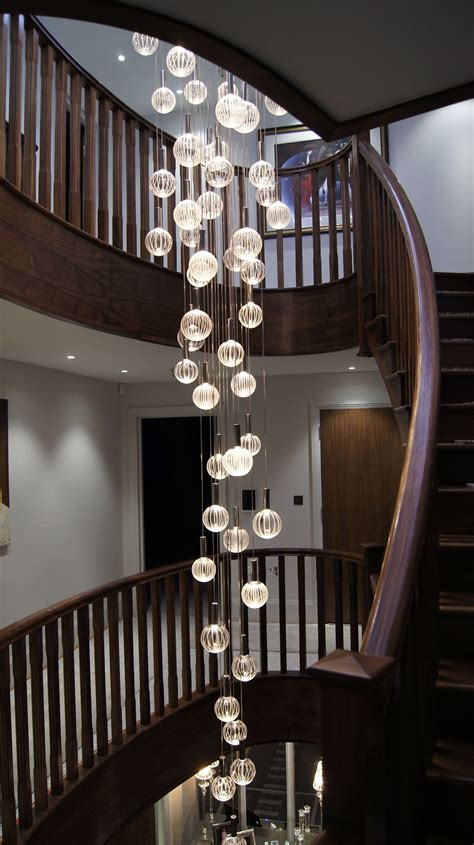 A Spiral Staircase With Glass Balls Hanging From It