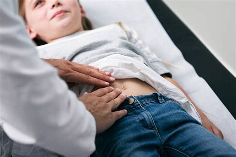 Exam Doctor Checks Belly Of Young Girl By Sean Locke