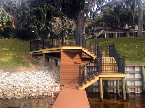 Trex deck cost can vary depending on several different factors. Trex Decking in the color saddle with black railing | Trex deck, Deck, Sea wall