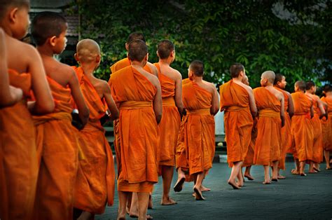 Buddhist Monks Walking Along The Street During The Daily Ritual