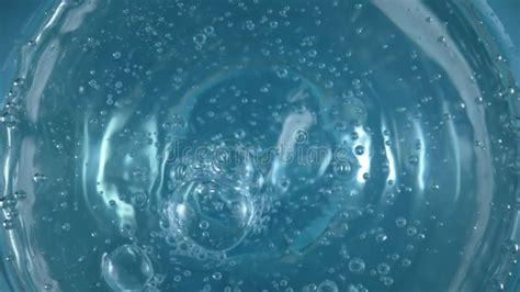 Top View Of A Spinning Surface Of Clear Blue Water With Air Bubbles