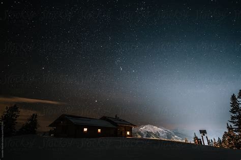 Wooden Alpine Cabin In Snowcovered Mountain Landscape At Night Under