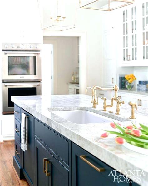 This bold navy works great on cabinetry and looks terrific with white and brass accents. painted kitchen cabinet ideas dark blue kitchen cabinets ...