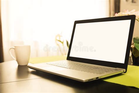 Workspace With Blank Screen Laptop On The Table At Home Stock Photo