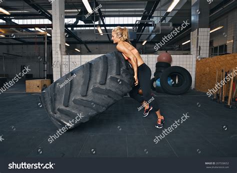 Fit Female Athlete Flipping A Huge Tire Muscular Young Woman Doing